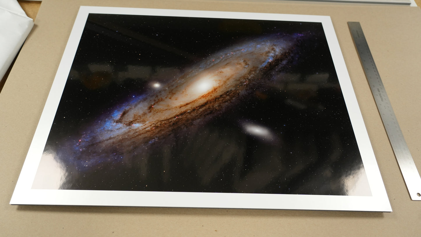 Framed photograph of a galaxy on a brown surface