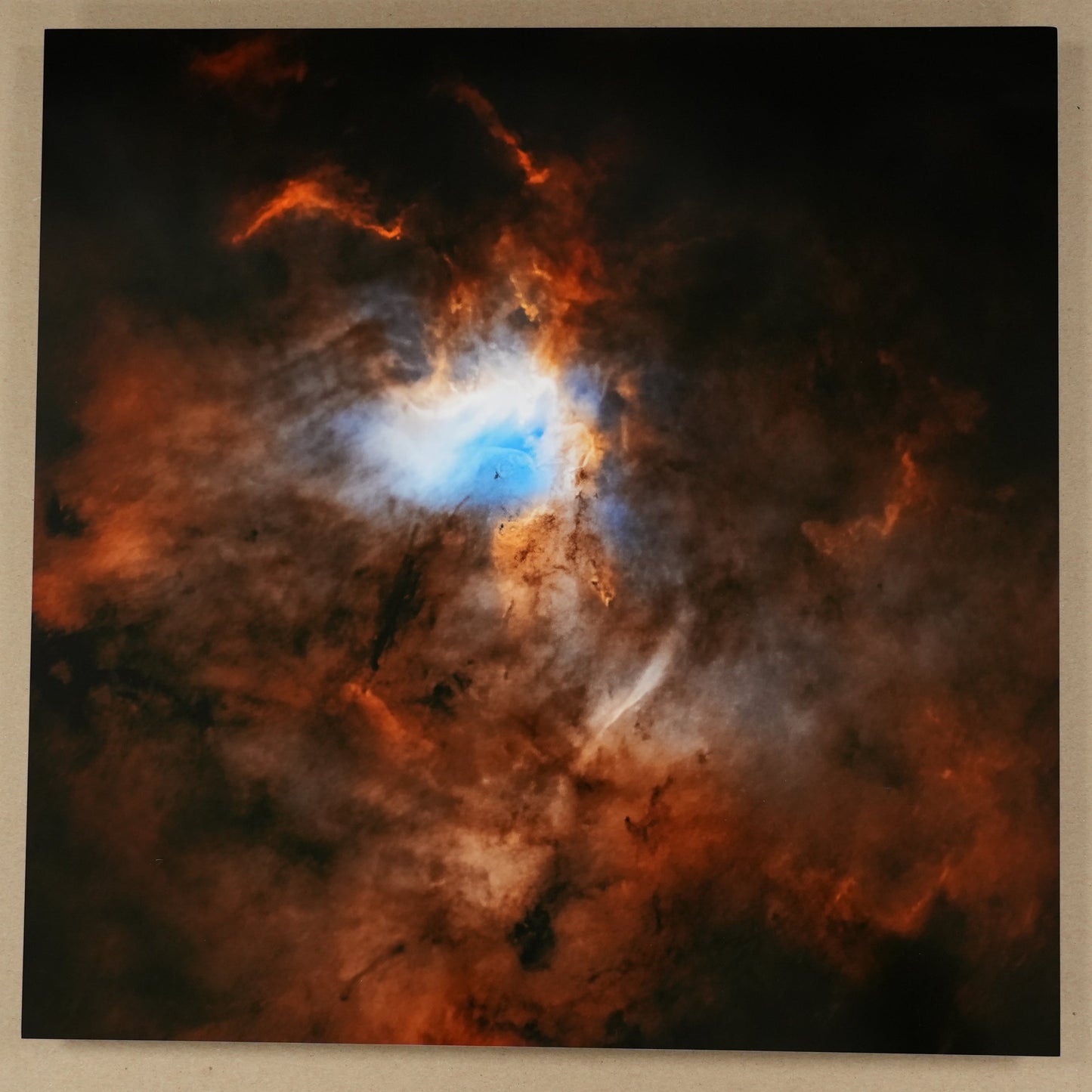Colorful nebula painting on a beige wall with a ruler for scale.