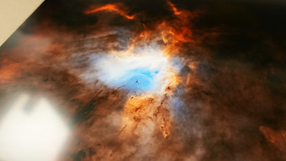 Star-forming region in space with a bright young star and surrounding gas and dust.