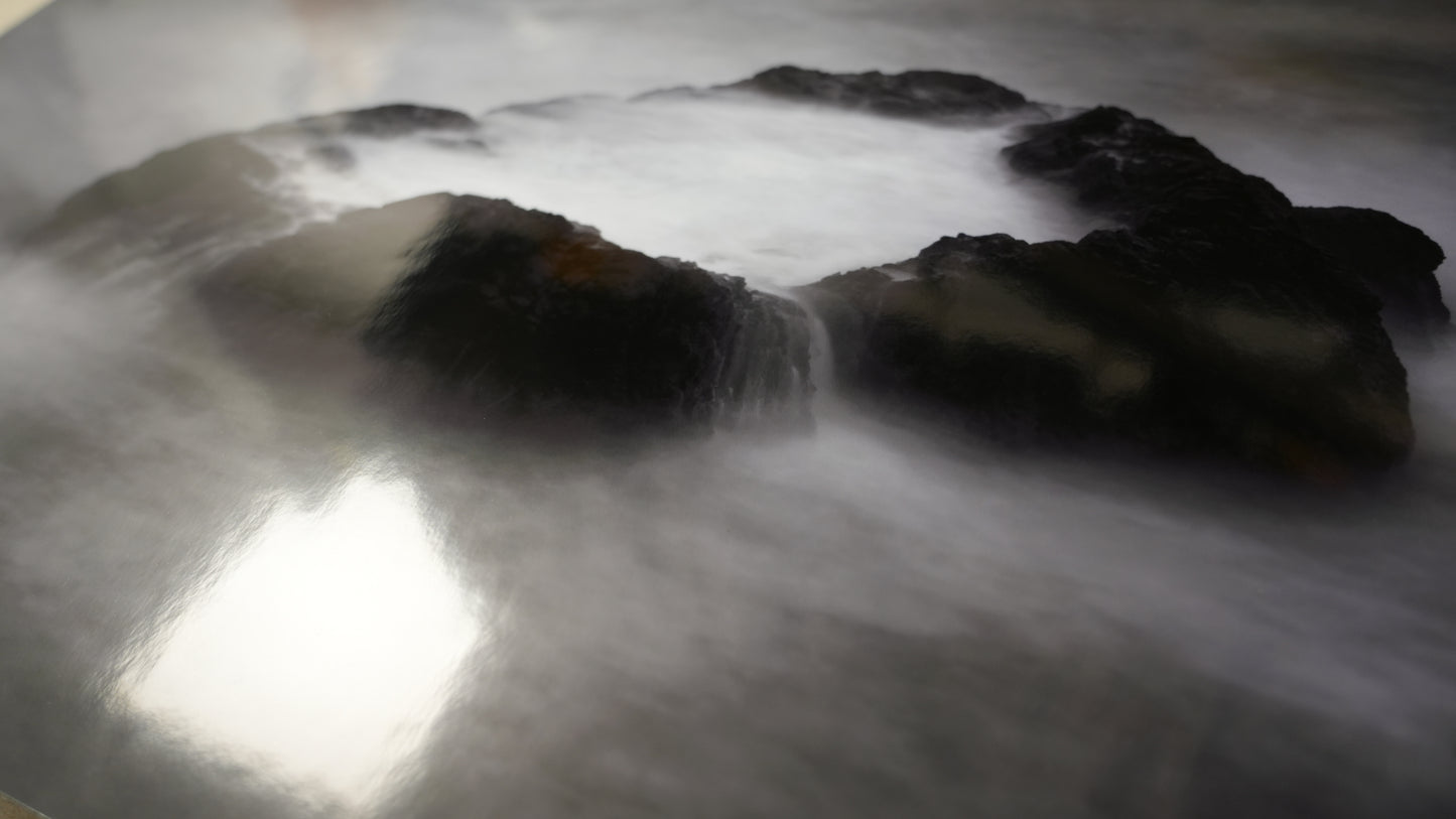 Rocks with water flowing over them in a natural setting