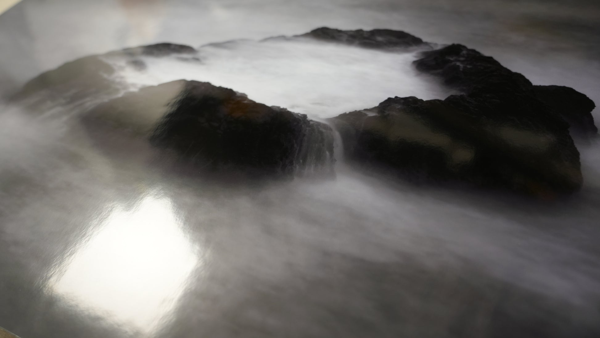 Rocks with water flowing over them in a natural setting