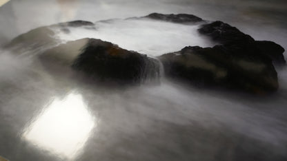 Rocks with water flowing over them in a natural setting