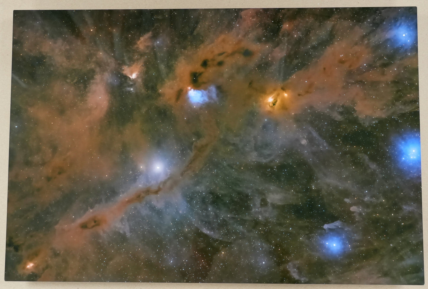 Framed photograph of a nebula with a ruler on the side