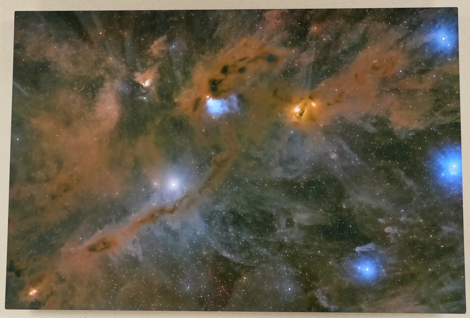 Framed photograph of a nebula with a ruler on the side