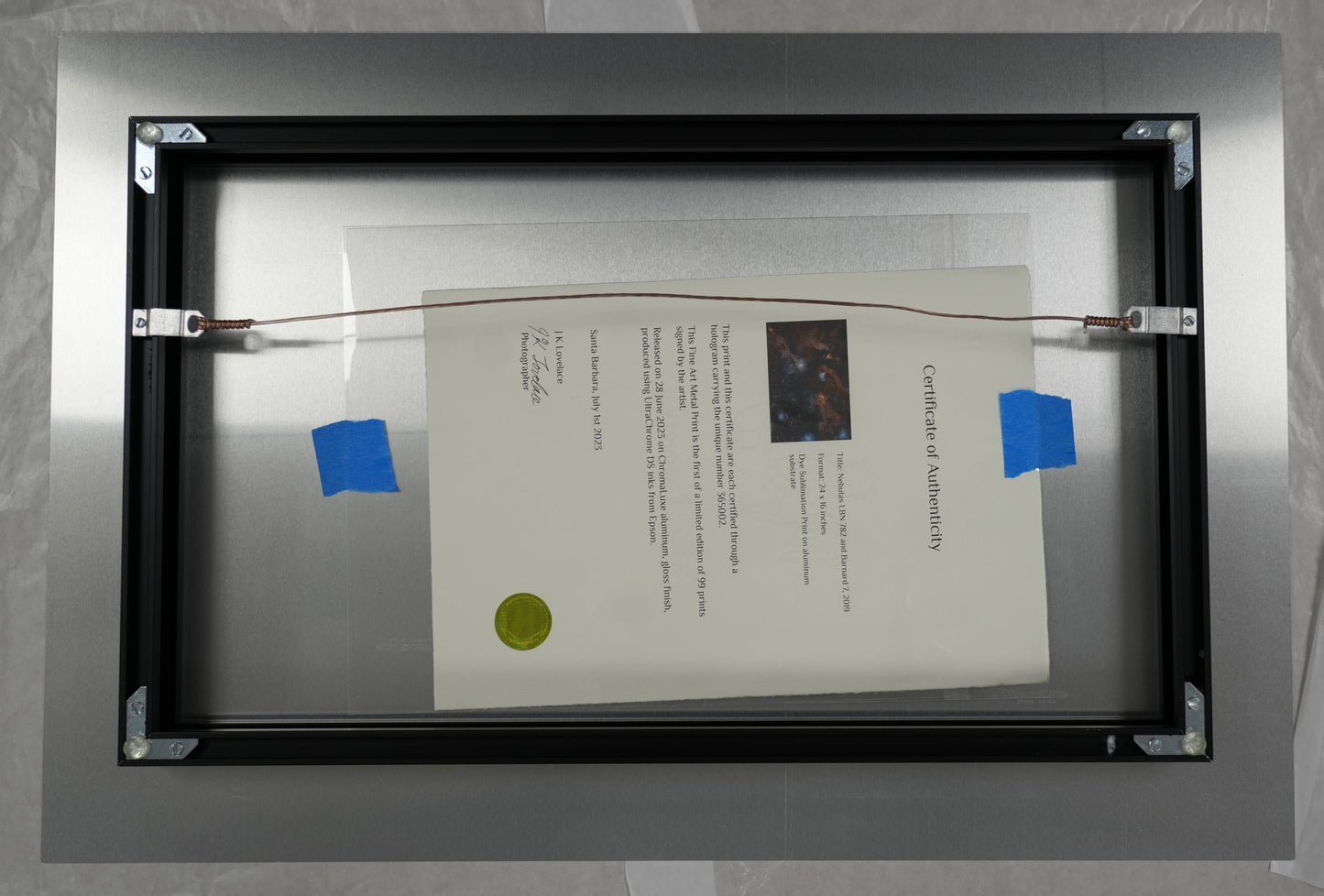 Framed document with a certificate inside, on a plain background