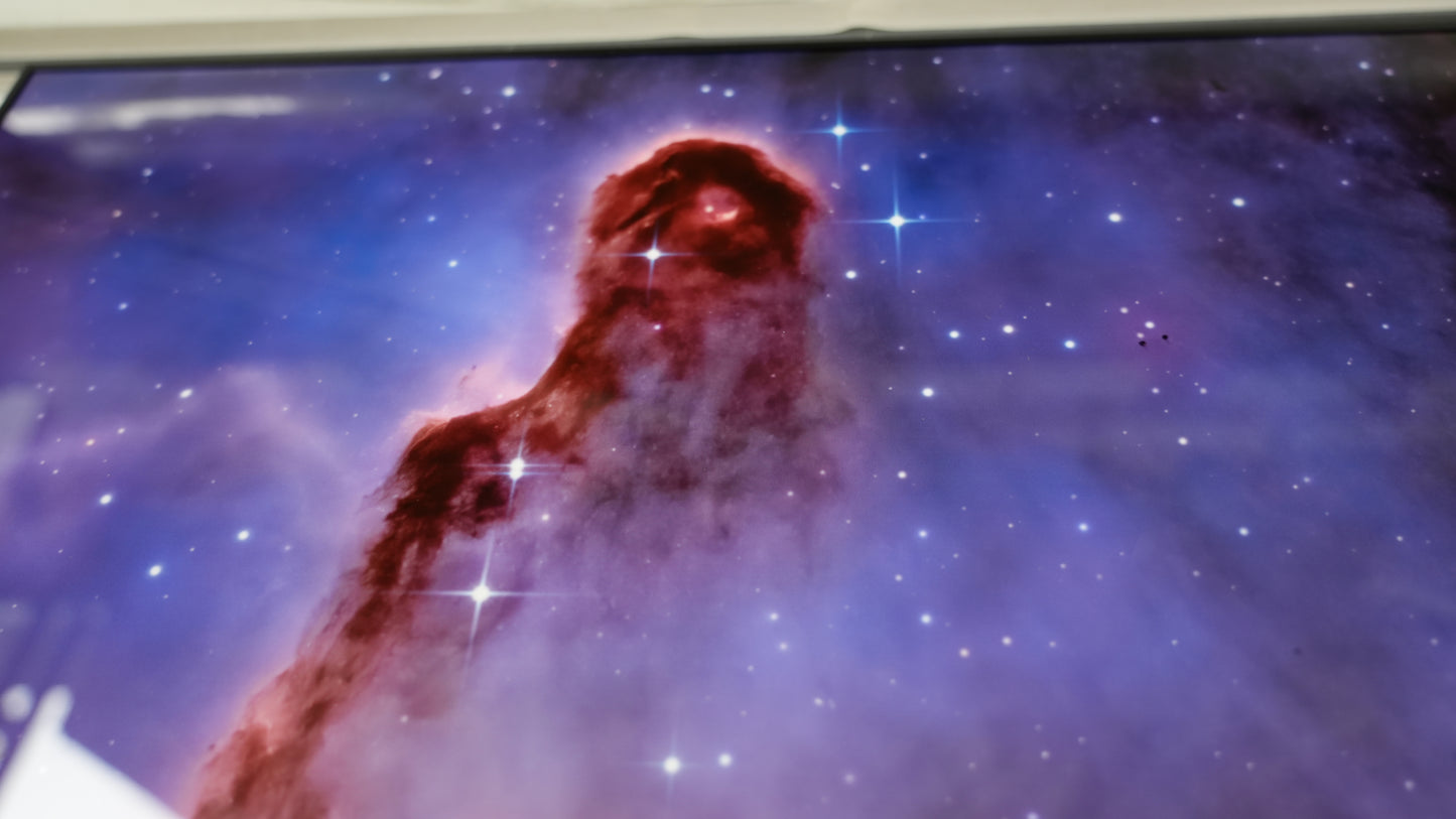 Nebula with a red and white cloud-like formation against a starry space background