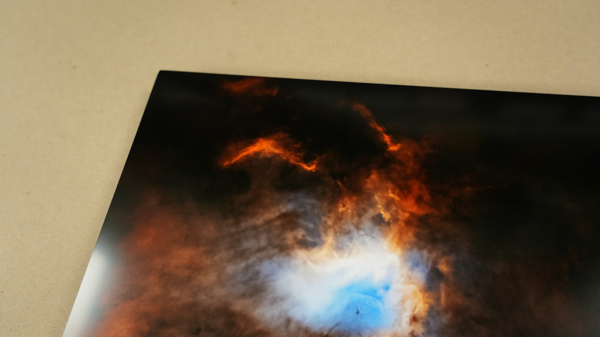 Close-up of a star-forming region in space with a bright blue core on a dark background.