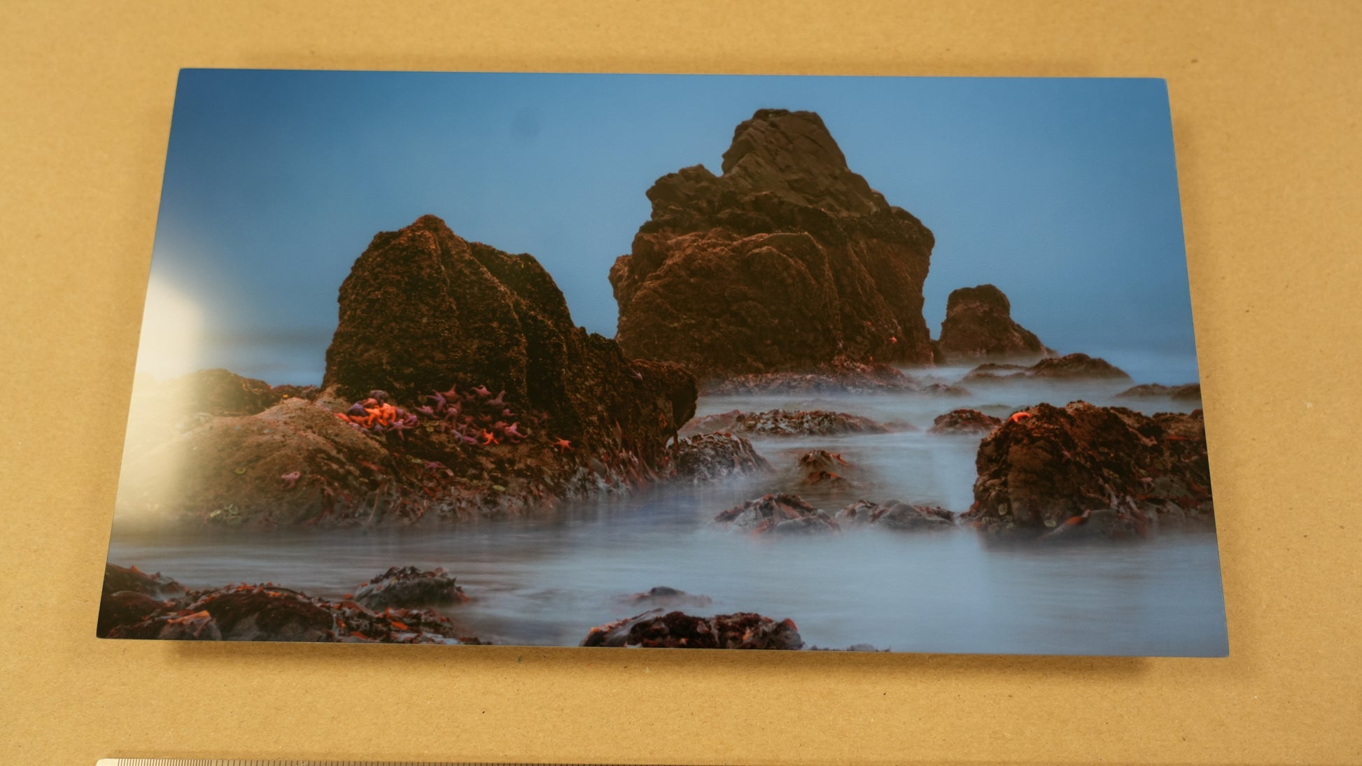 Scenic photo of rocky coastline with water on a beige background