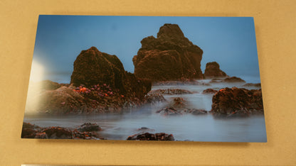 Scenic photo of rocky coastline with water on a beige background