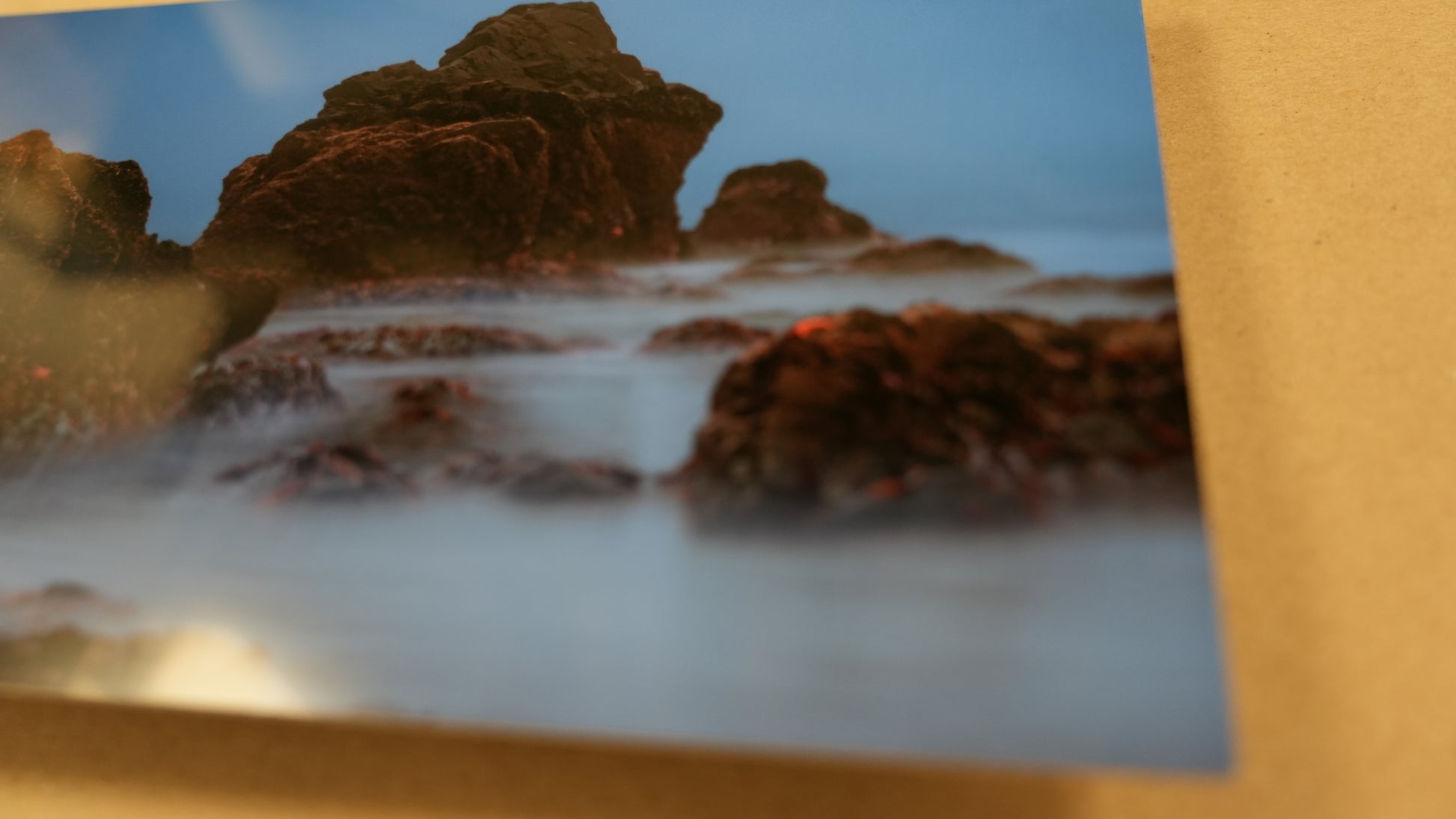 Rocks with water splashing around them on a beach