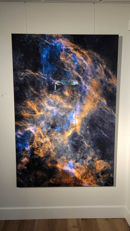 A photograph of the 44x66 inch metal print titled "DWB 111/Double Helix" on display at Slice of Light Gallery