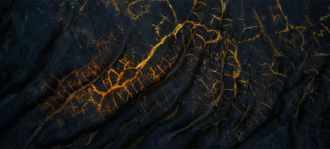 A jpg of a photograph titled "Golden Veins" shot by landscape photographer Ben Coffman featuring veins of unknown minerals gleaming like gold in cooled lava after the Fagradalsfjall eruption, Iceland