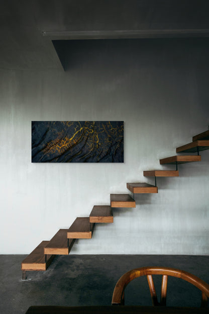 A wall art mockup featuring the photograph titled "Golden Veins" by landscape photographer Ben Coffman as a 48 inch wide metal print with inset frame on display in an industrial loft.