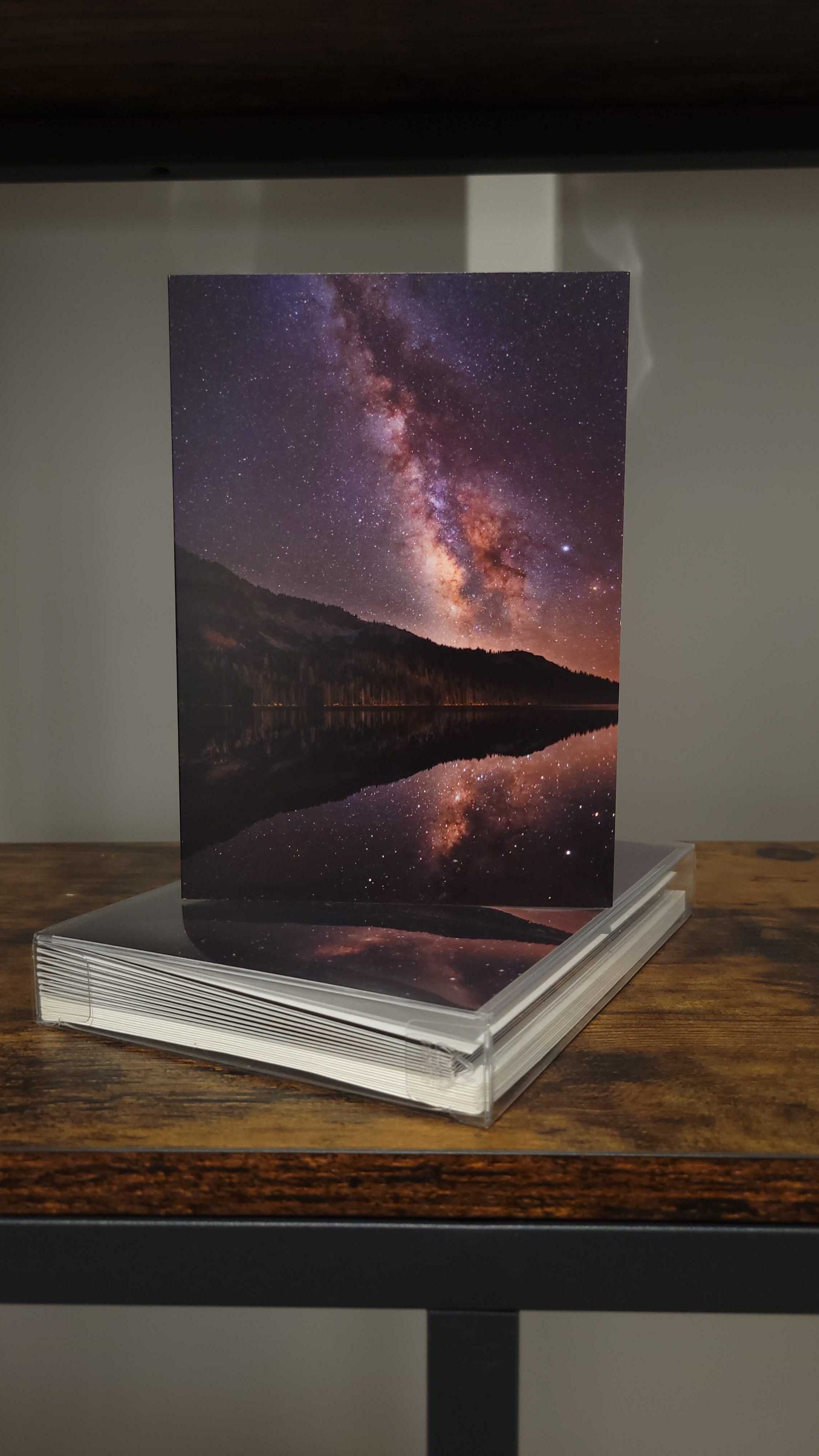 A photograph of a holiday greeting card set featuring the photograph titled "High Lake" on the front over.