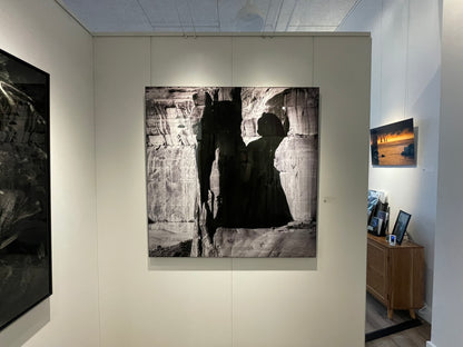 Art gallery with large black and white photograph of a silhouette against a canyon wall.