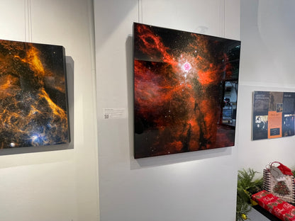 Artistic representations of nebulae on a wall display
