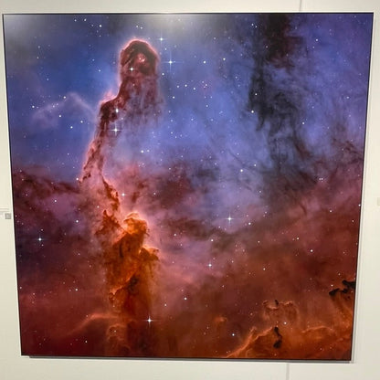Starry night sky with a nebula on a white wall