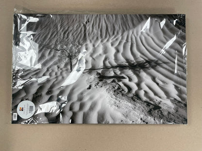 Black and white sand dune pattern on a packaging surface
