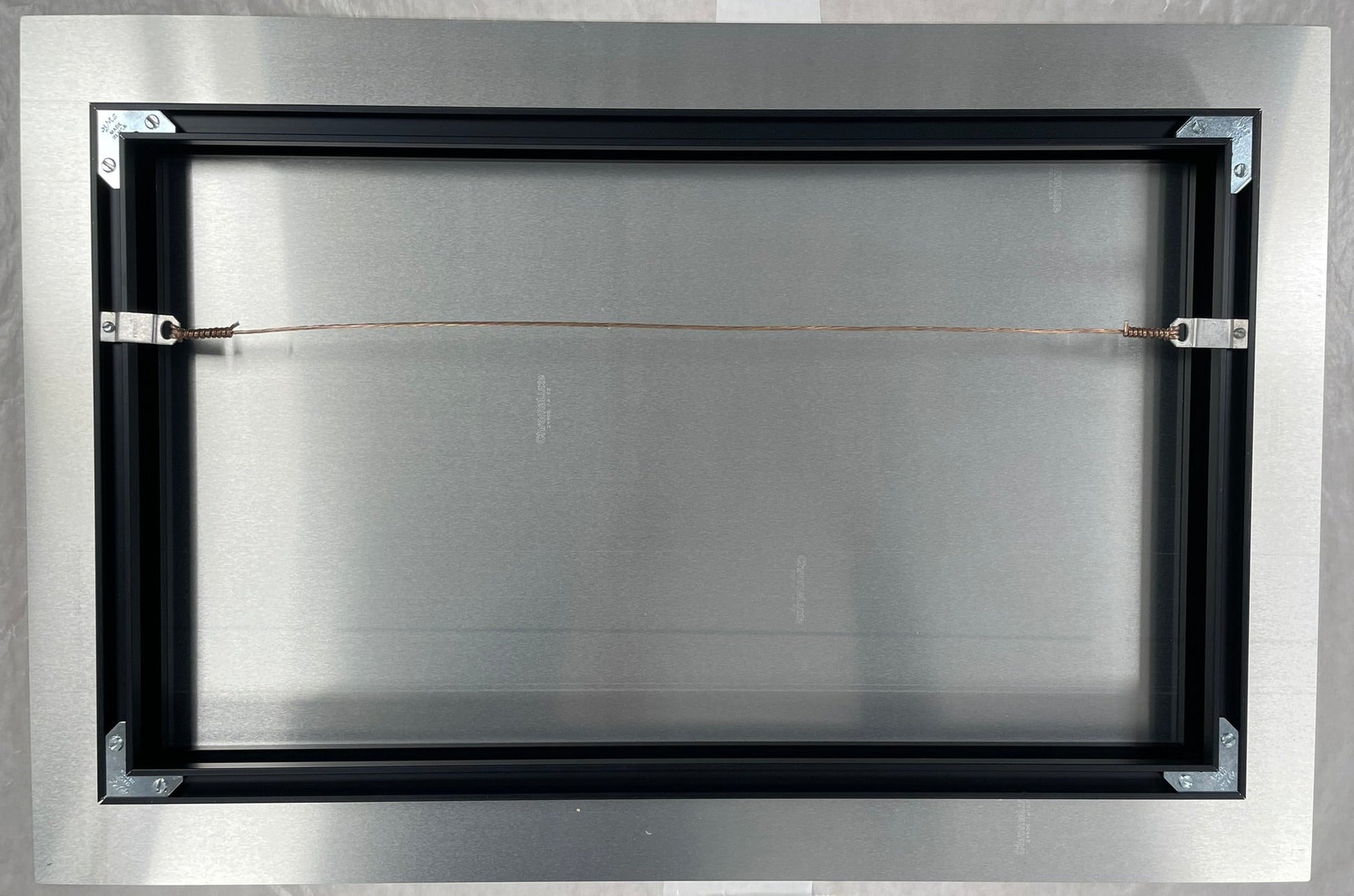 Metallic frame with a reflective surface on a white background