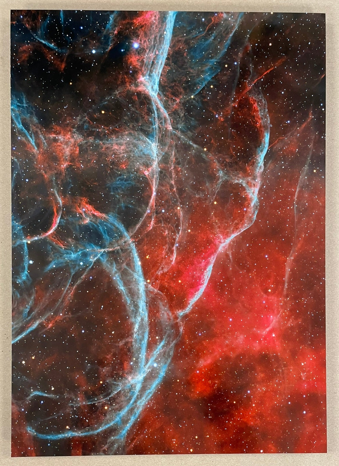 Colorful nebula artwork on a textured beige background