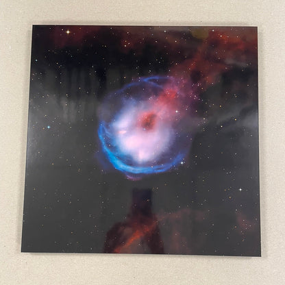 Starry night sky with a colorful nebula on a textured surface