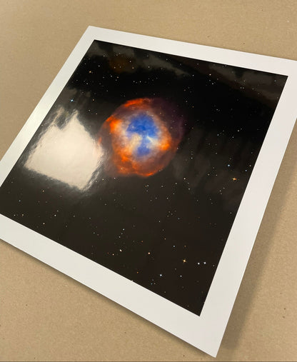 Stylized depiction of a nebula on a white border with a brown background