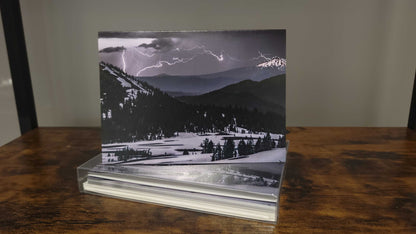 A photograph of a holiday greeting card set featuring the photograph titled "Lightning and Ice" on the front cover