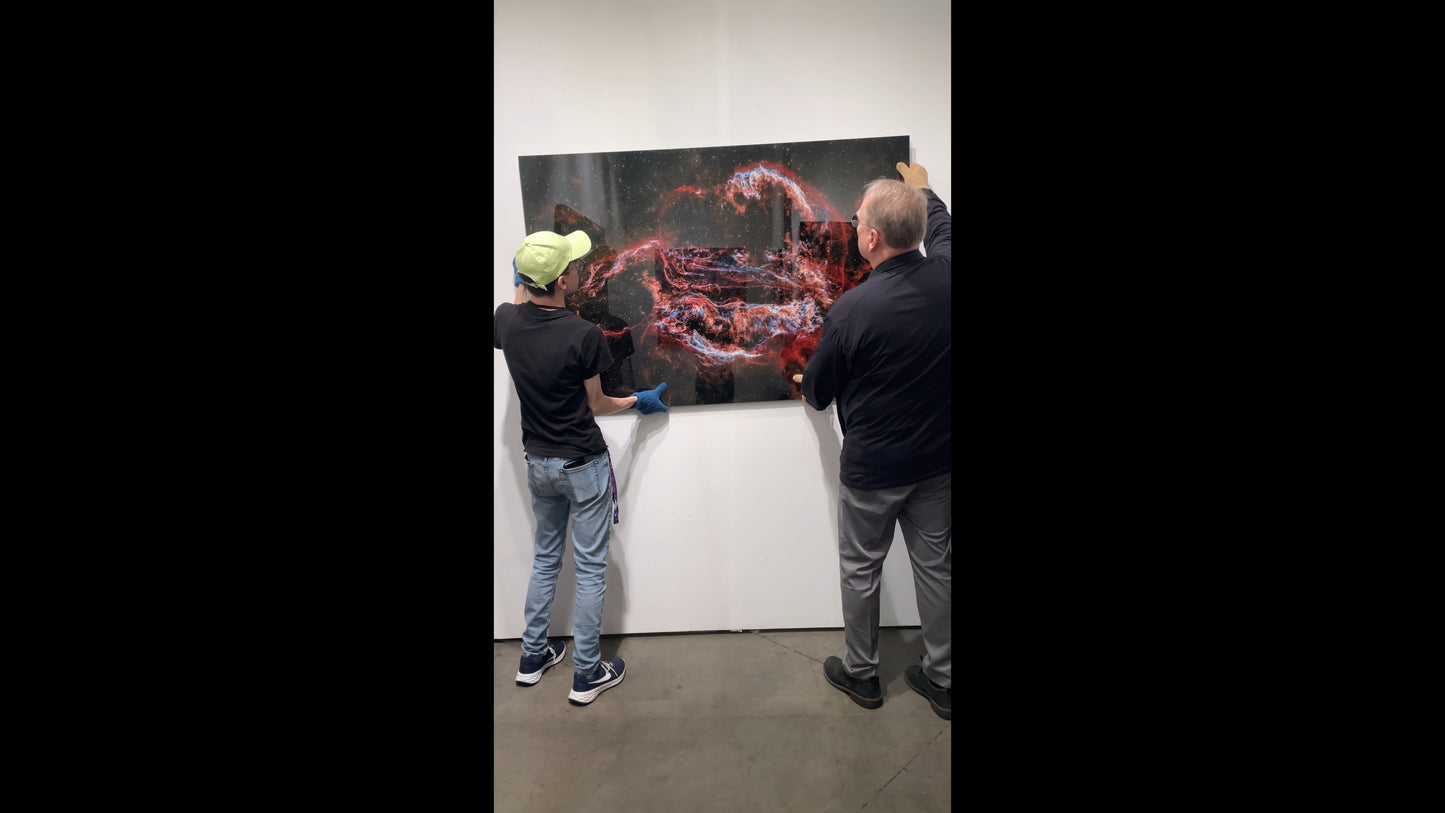 Two people examining a large abstract painting in an art gallery.