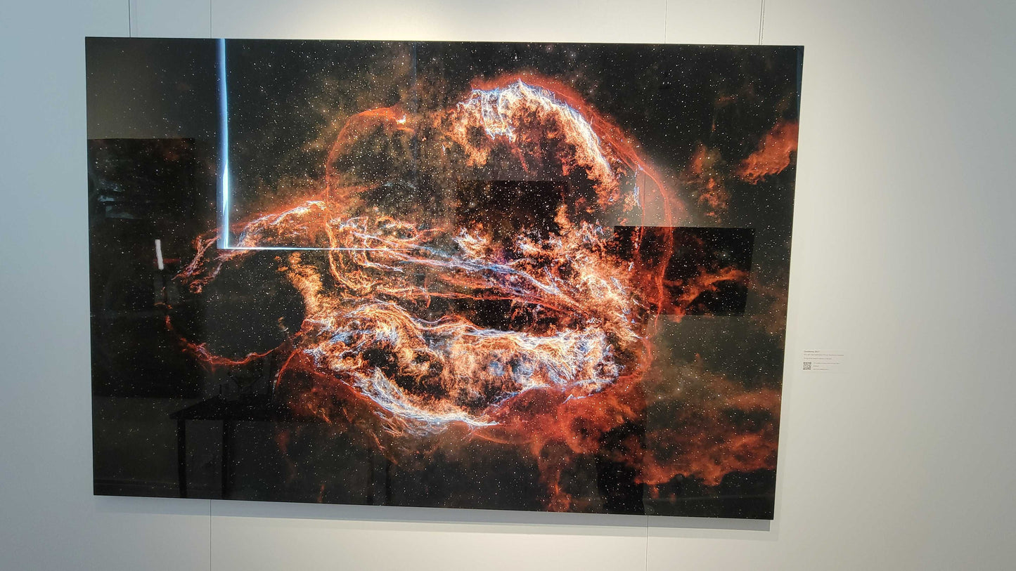 A photograph of the metal print in inset frame and glossy finish titled, "Ouroboros" shot by astrophotographer J K Lovelace, on display in Slice of Light Gallery.