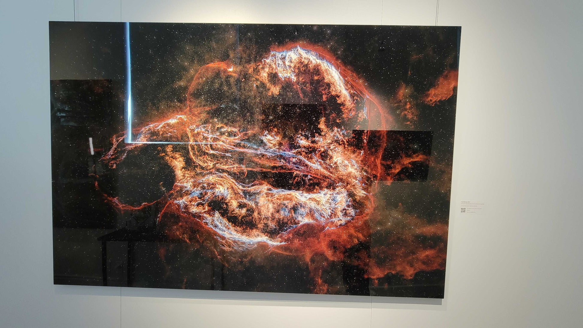 A photograph of the metal print in inset frame and glossy finish titled, "Ouroboros" shot by astrophotographer J K Lovelace, on display in Slice of Light Gallery.