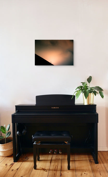 A wall art mockup featuring the photograph titled "Shadow Archetype" by landscape photographer Ben Coffman as a 24 inch wide metal print with inset frame on display in a modern apartment above a piano.