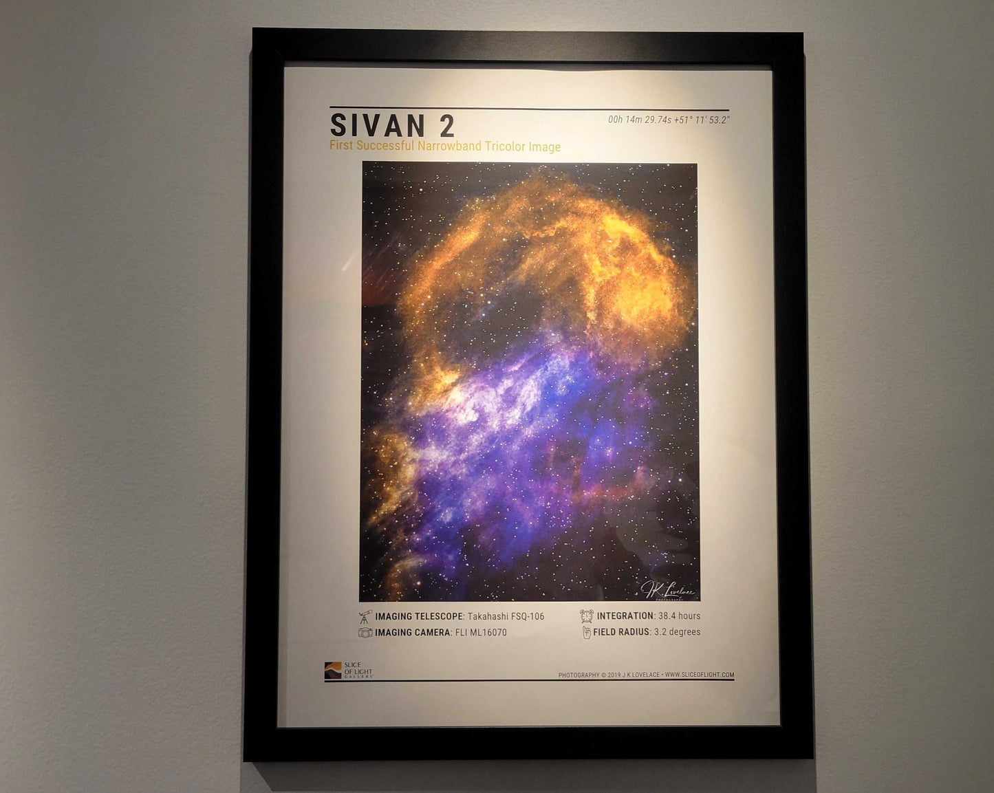 A photograph of a 18x24 inch poster of Sivan 2 in a black frame on display in Slice of Light Gallery