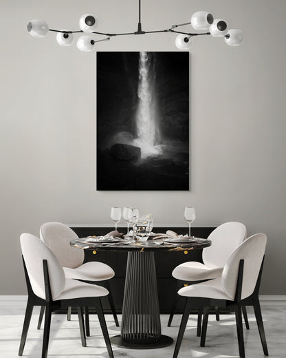 A wall art mockup featuring the photograph titled "Spring Waterfall, Iceland" by landscape photographer Ben Coffman as a 30 inch wide metal print with inset frame on display in a modern dining room.