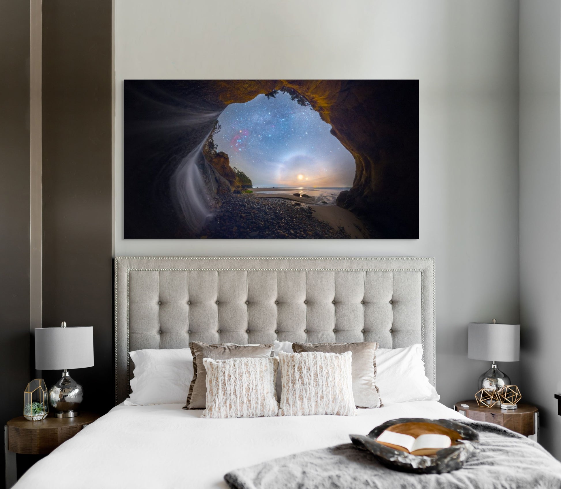 A wall art mockup featuring the photograph titled "Starfalls II" by landscape photographer Ben Coffman as a 60 inch wide metal print with inset frame on wall above bed in a modern california coastal bedroom.
