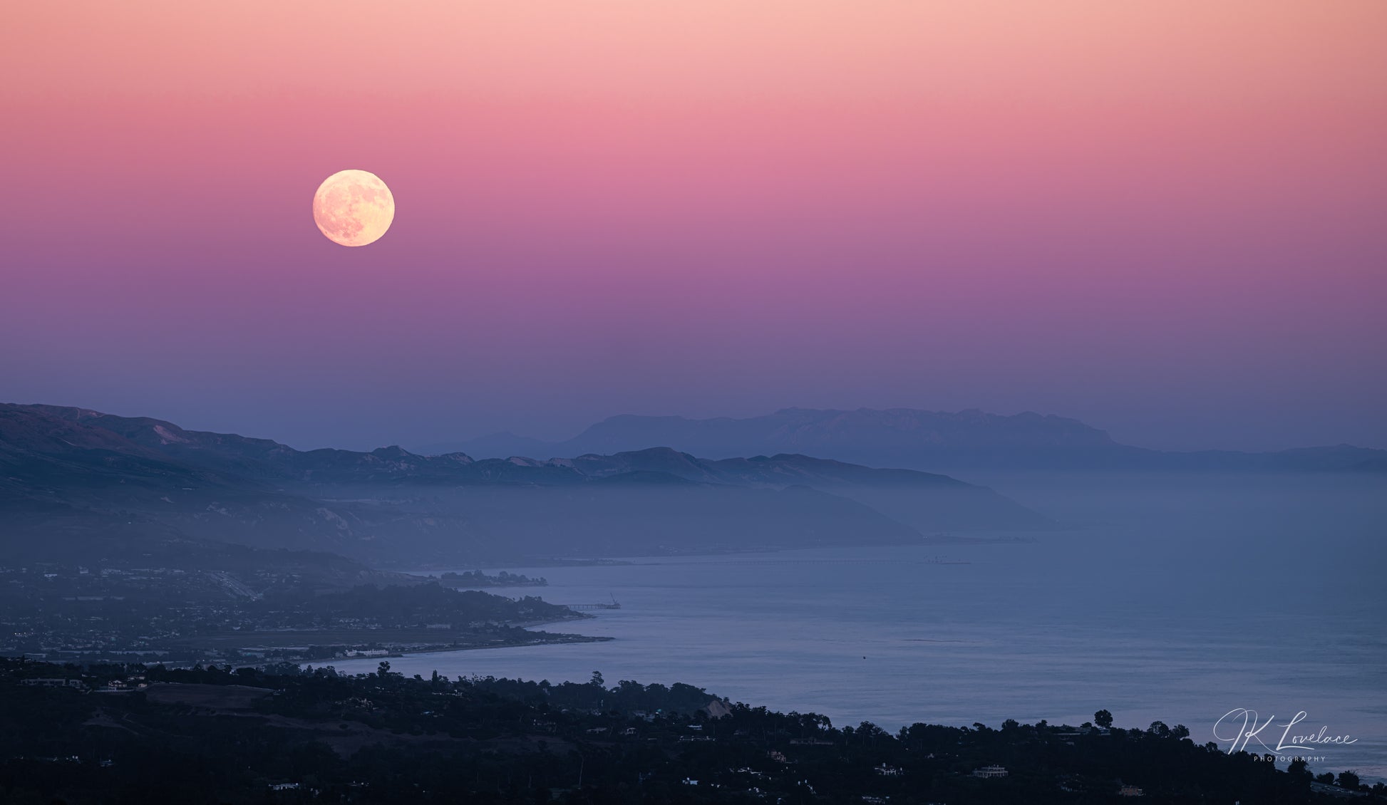 A jpg of the photograph titled "Supermoon Over Summerland" shot by landscape photographer J K Lovelace, featuring the coastline of Summerland, California