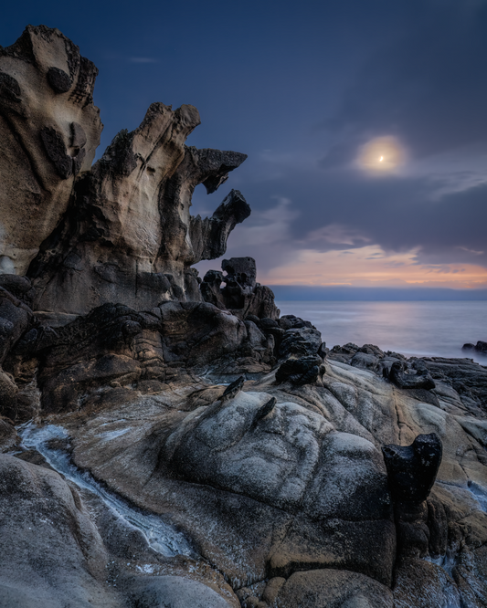 A png of the seascape photograph titled "The Ancient Mariner" shot by landscape photographer J K Lovelace featuring interesting rock formations, the sea, and a cloudy moon.