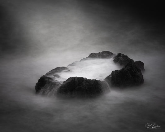 A jpg of the seascape photograph titled "Tranquil Violence" shot by landscape photographer J K Lovelace featuring a Sonoma Coast boulder and sea water.