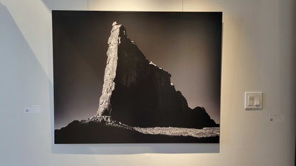 A photograph of the metal print titled "Tower of Babel" on display at Slice of Light Gallery.