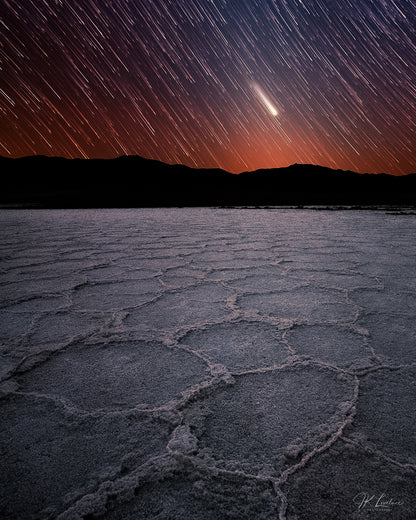 A jpg of the photograph titled "When Beginnings End" shot by landscape photographer J K Lovelace, featuring  a timelapse/startrail vertical panorama of 
 the Racetrack Playa.