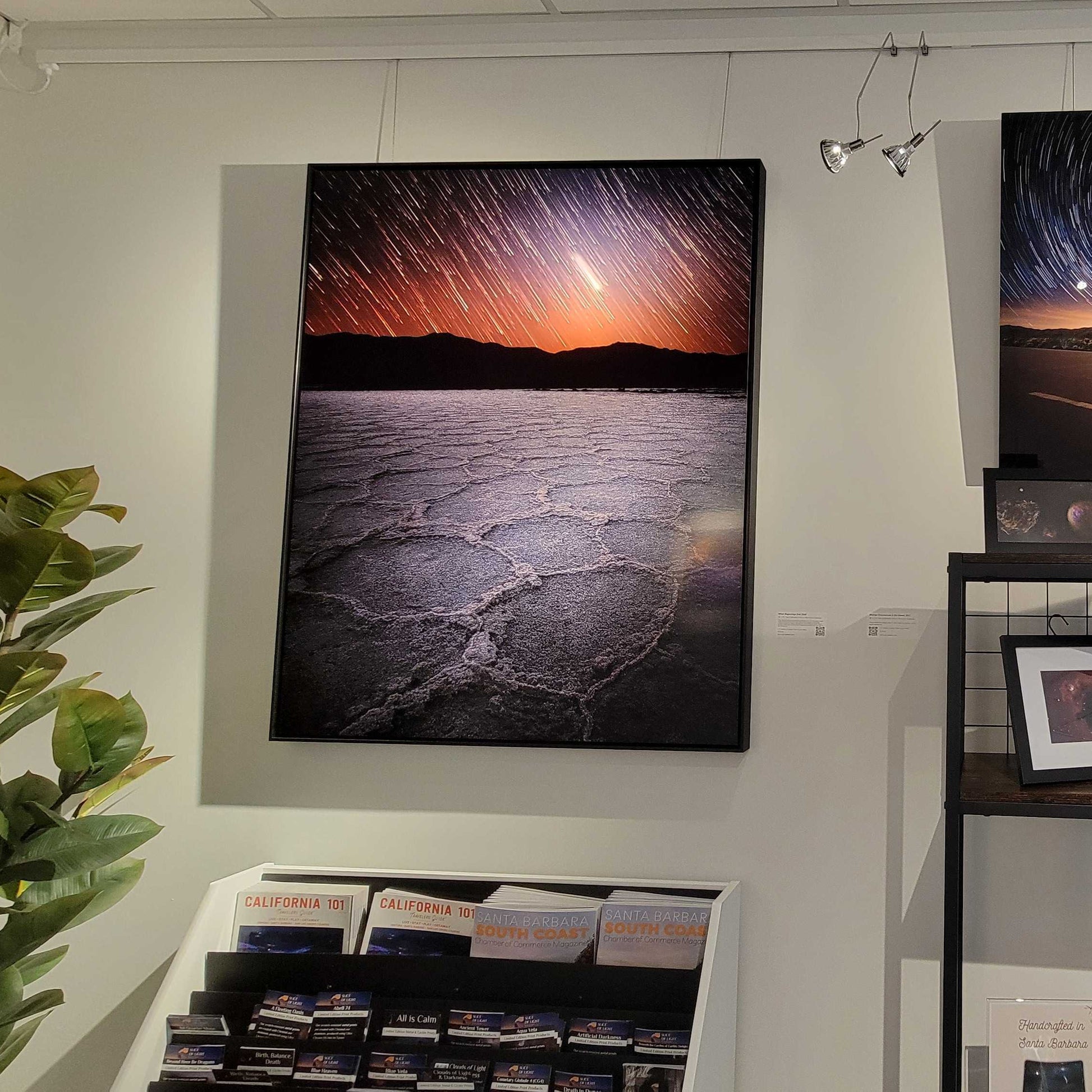 A photograph of the metal print in shadow box frame titled "When Beginnings End" on display in Slice of Light Gallery