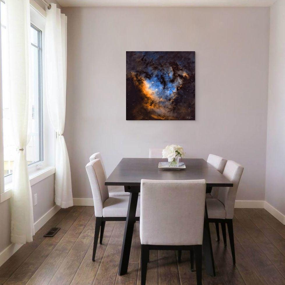 A framed abstract artwork titled 'Blue Heaven' displayed above a dining area, featuring a cloudy blue sky.