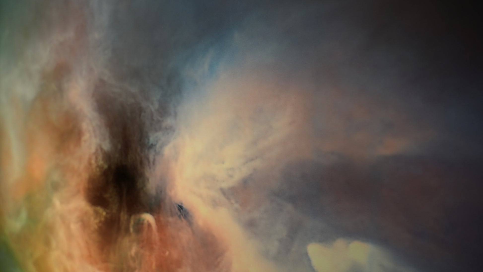 Abstract painting with swirling colors on a dark background