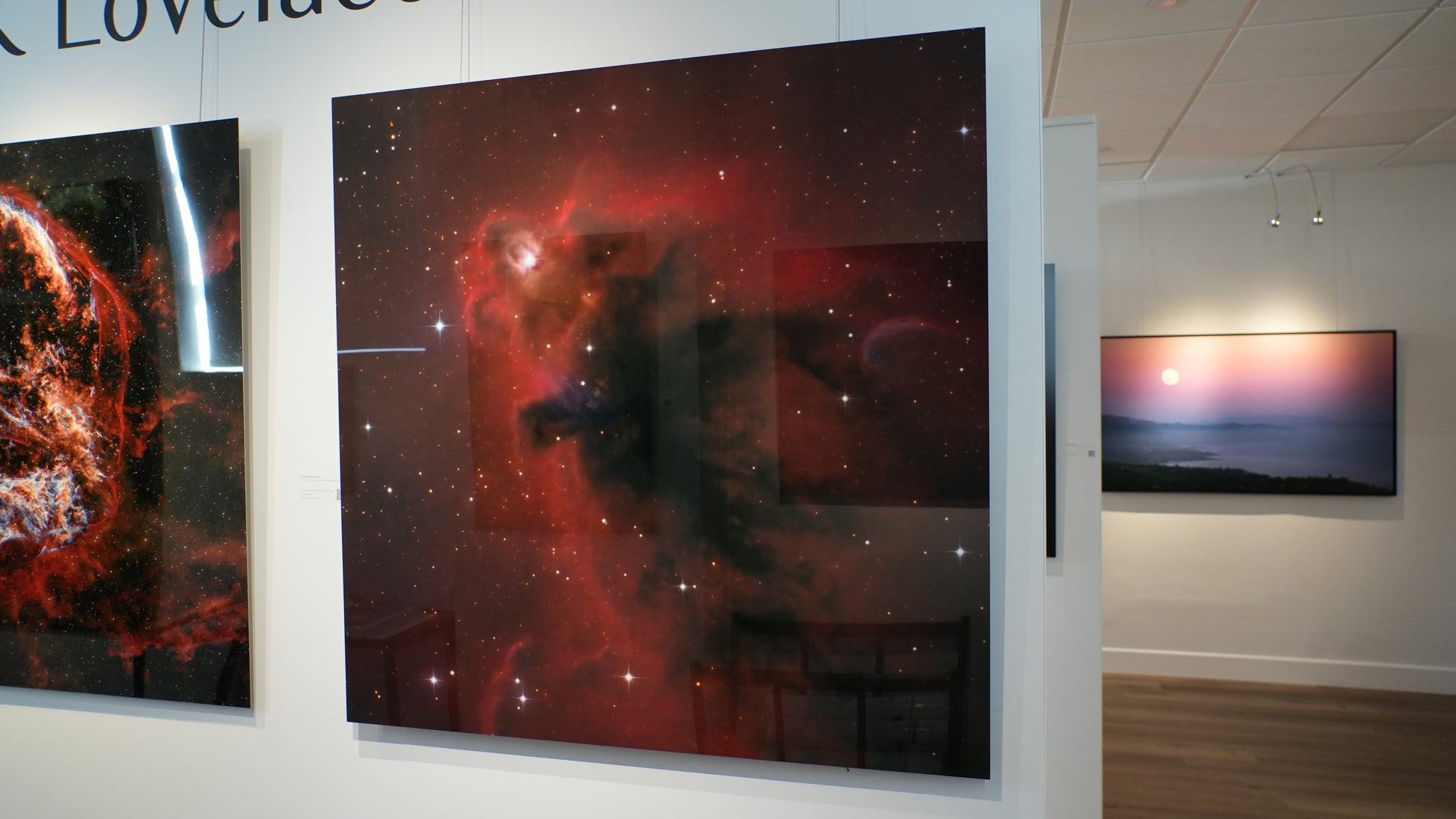 Artistic representations of celestial phenomena on a wall display.