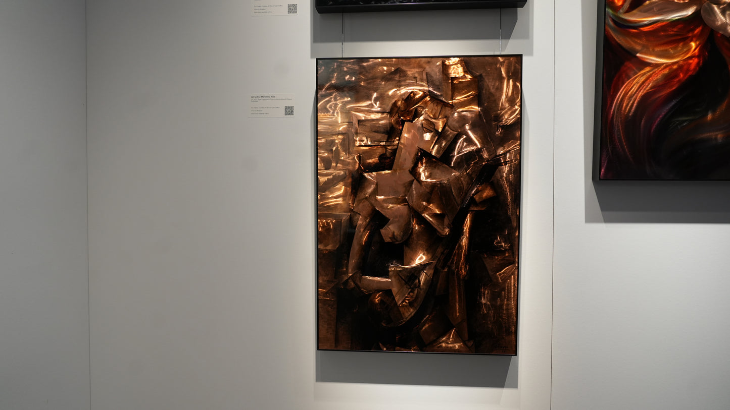 Abstract art piece in a frame on a gray wall