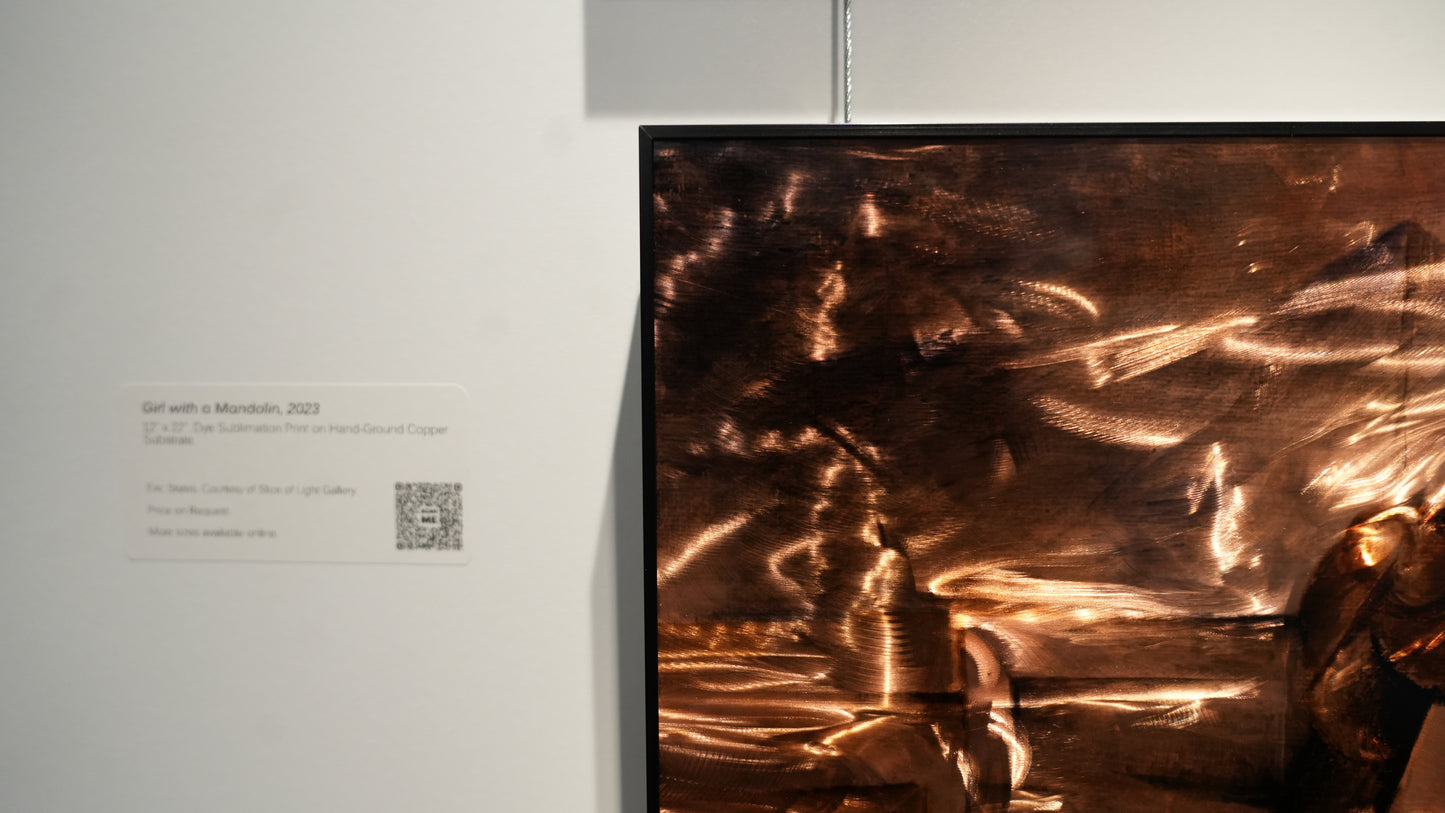 Abstract artwork on a wall with a QR code label