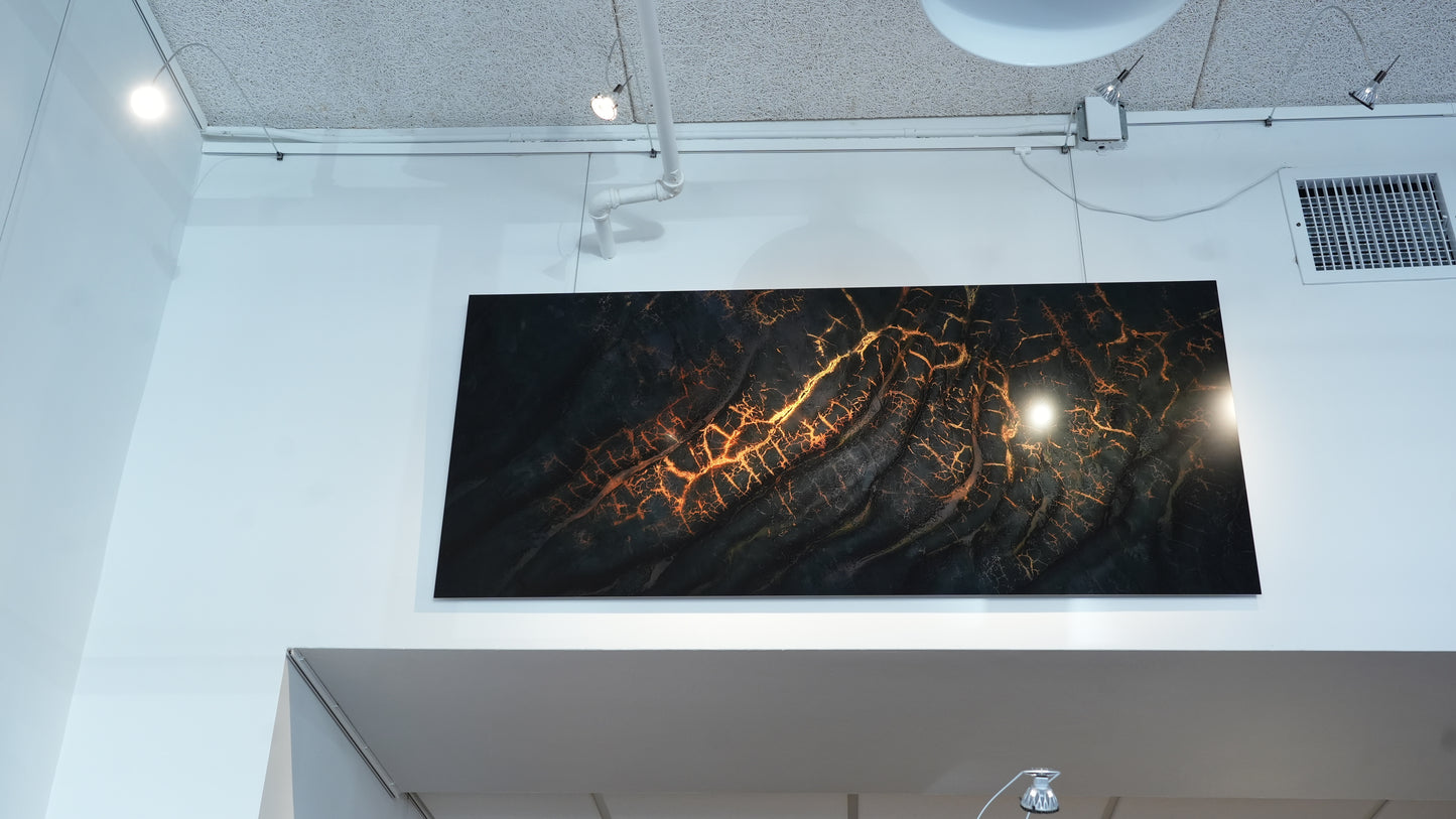 Large abstract art piece on a wall in an indoor setting