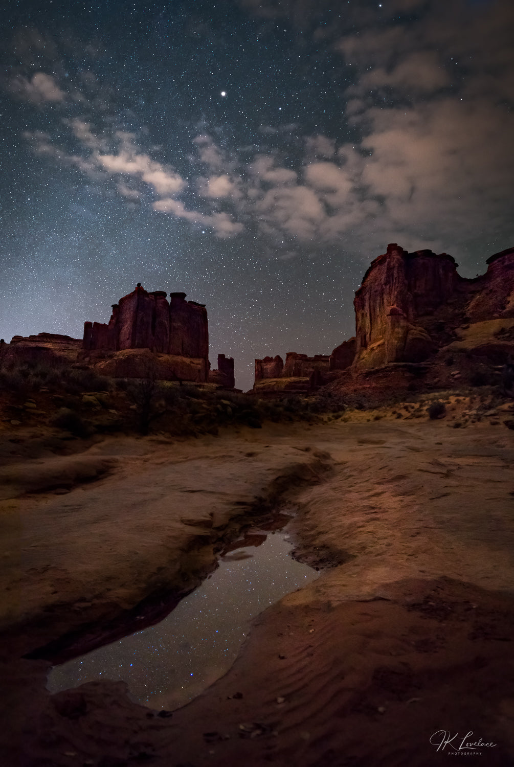 A jpg of the nightscape photograph titled "A Fleeting Oasis" shot by landscape photographer J K Lovelace featuring a tiny oasis in Arches National Park, Utah, USA