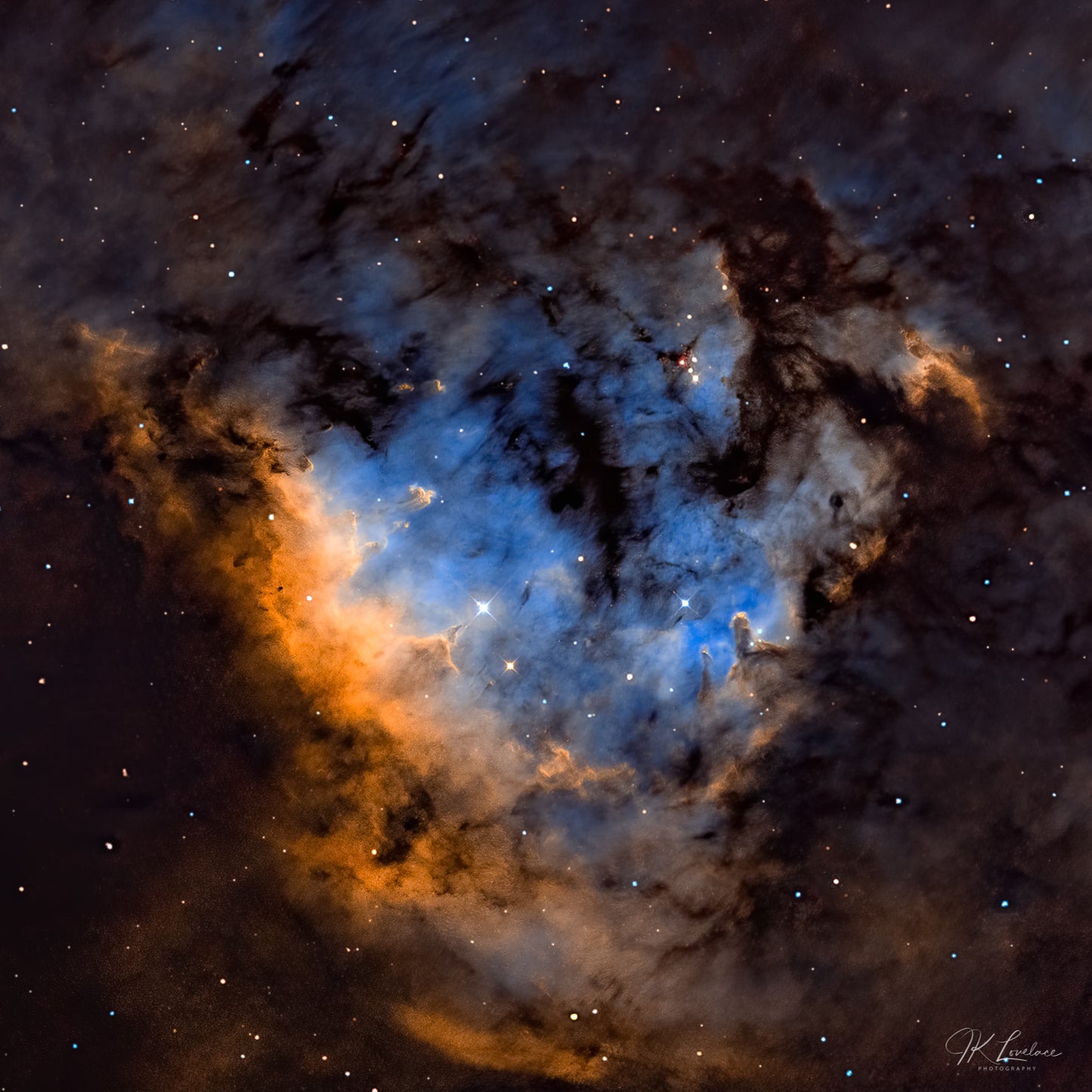 A jpg of the deep sky photograph titled "Blue Heaven" shot by astrophotographer J K Lovelace featuring star forming region known as CED 214, NGC 7822, and Sh2-171 glowing like a heavenly gateway.