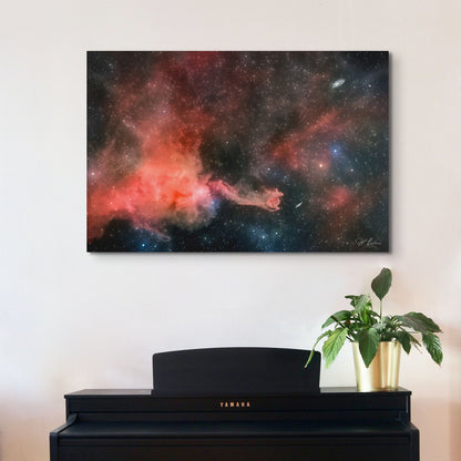 A wall art mockup of the metal print titled "Cometary Globule 4 (CG4)" on white wall above a black upright piano