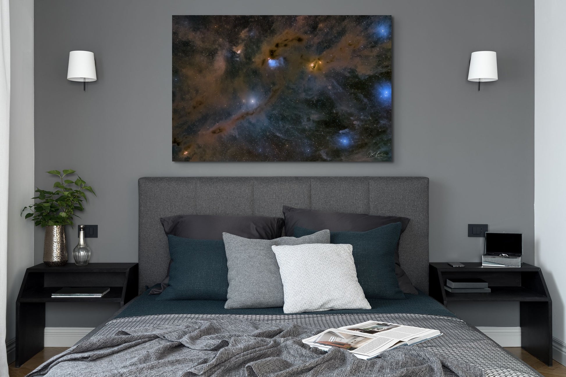 A wall art mockup featuring the 44 inch wide metal print in inset frame titled "Nebulas LBN 782 and Barnard 7" on display in a dark colored contemporary bedroom.